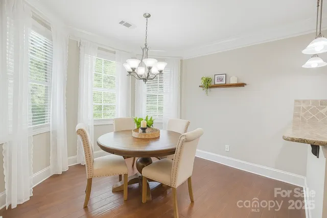 a view of a dining room with furniture and chandelier