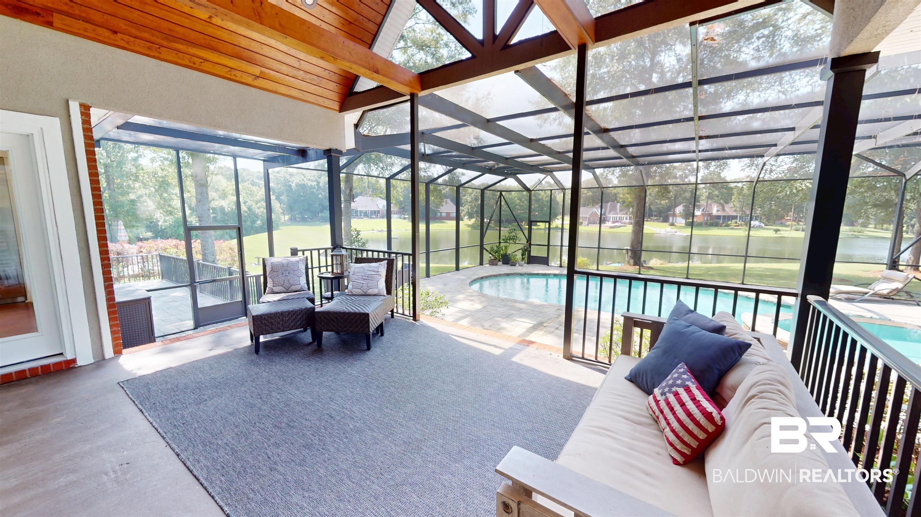 8775 Dawes Lake Road North Mobile, AL 36619 - Photo 40 of 59 Sunroom featuring a water view, outdoor lounge area, and a pool