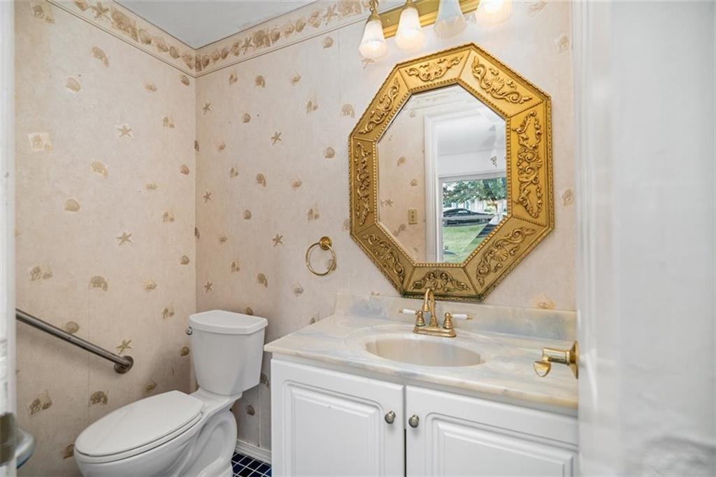 4 Dendron Drive Coraopolis, PA 15108 - Photo 7 of 36 a bathroom with a sink a mirror a toilet and a window