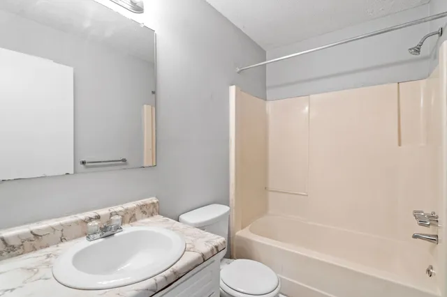 a bathroom with a sink a toilet and a bathtub