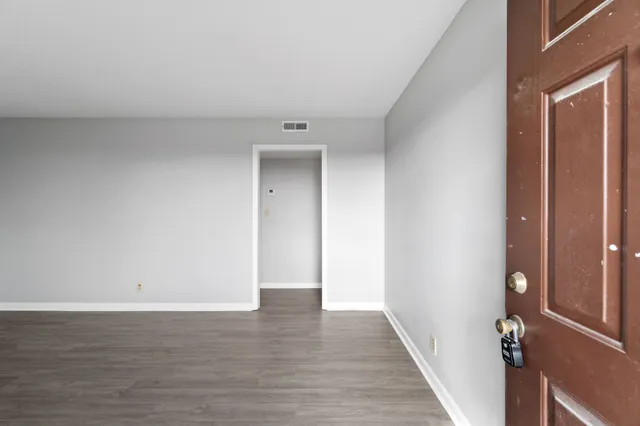 a view of a room with wooden floor