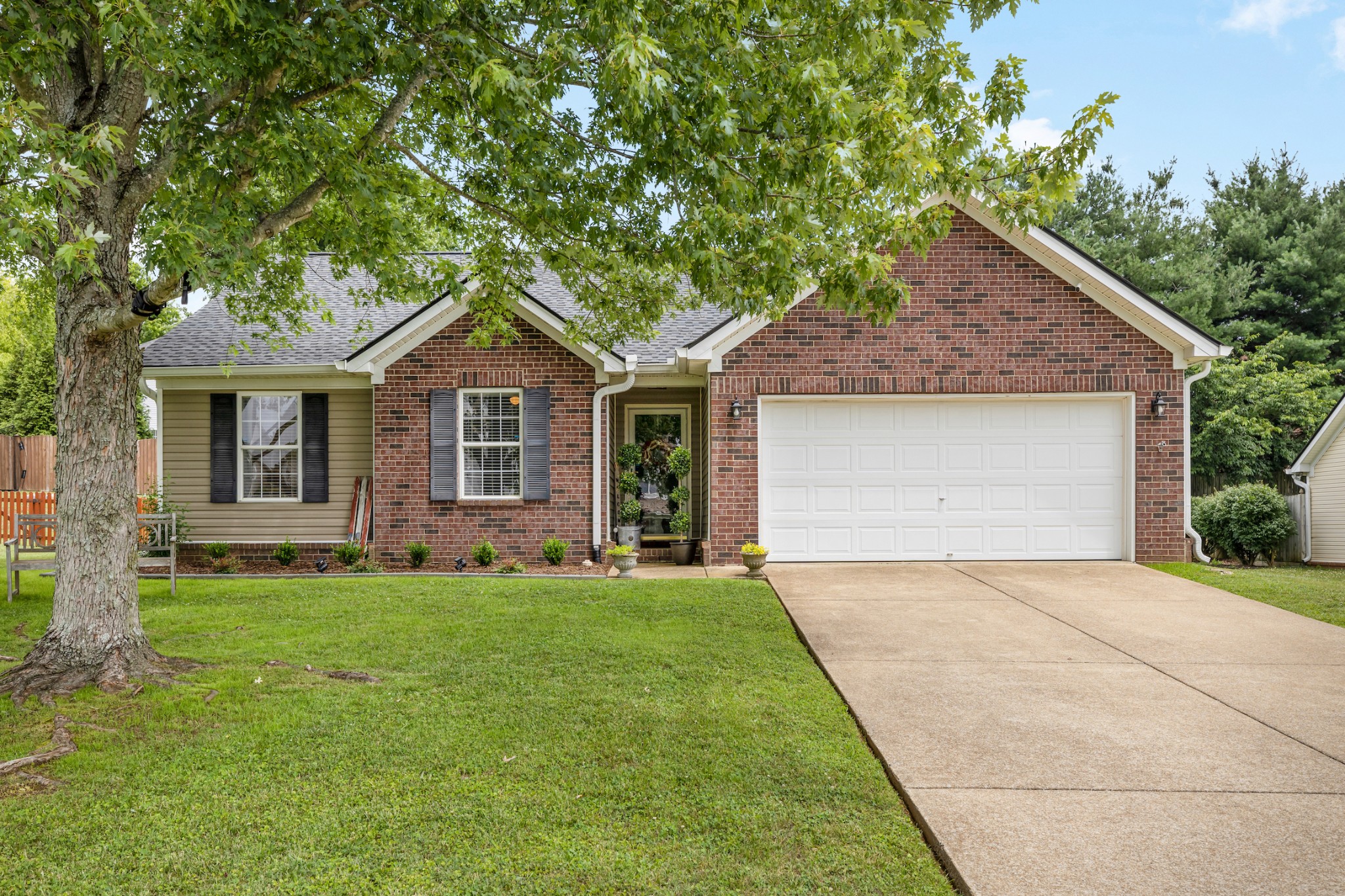 1936 Portway Road Spring Hill, TN 37174 - Photo 1 of 17 a front view of a house with a garden