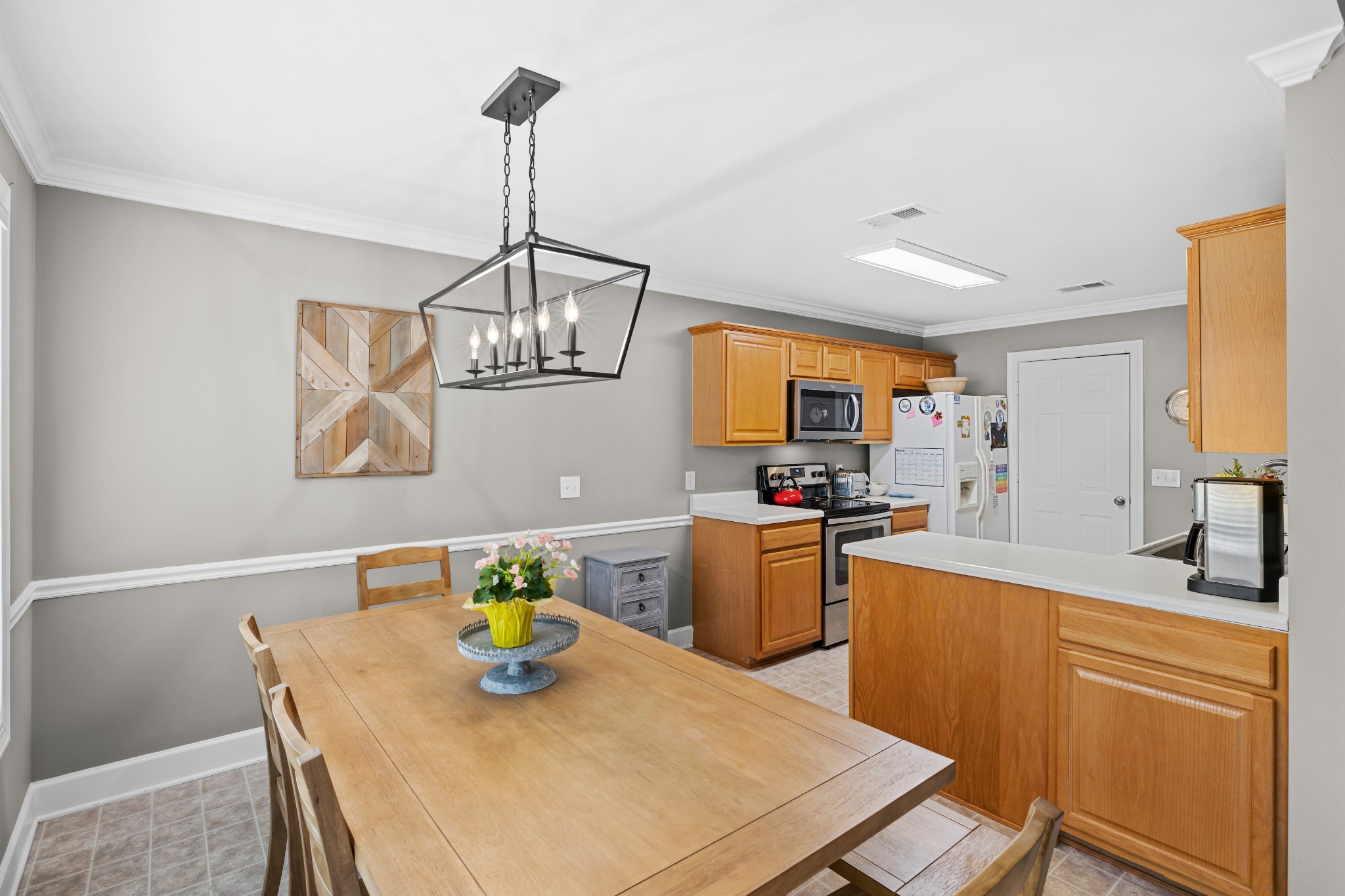 1936 Portway Road Spring Hill, TN 37174 - Photo 5 of 17 a kitchen with stainless steel appliances a dining table and chairs