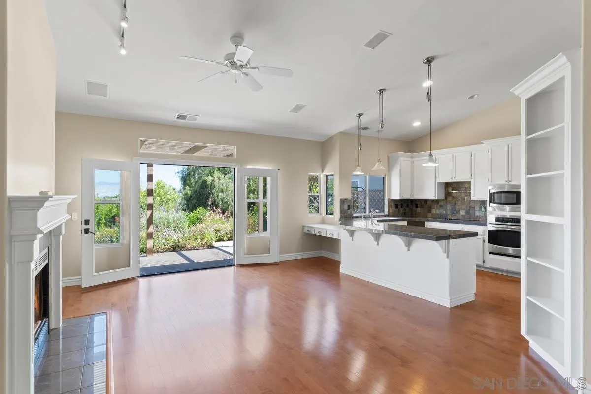 544 Alpine Trail Road Alpine, CA 91901 - Photo 23 of 52 a large kitchen with kitchen island a large window a sink stainless steel appliances and cabinets