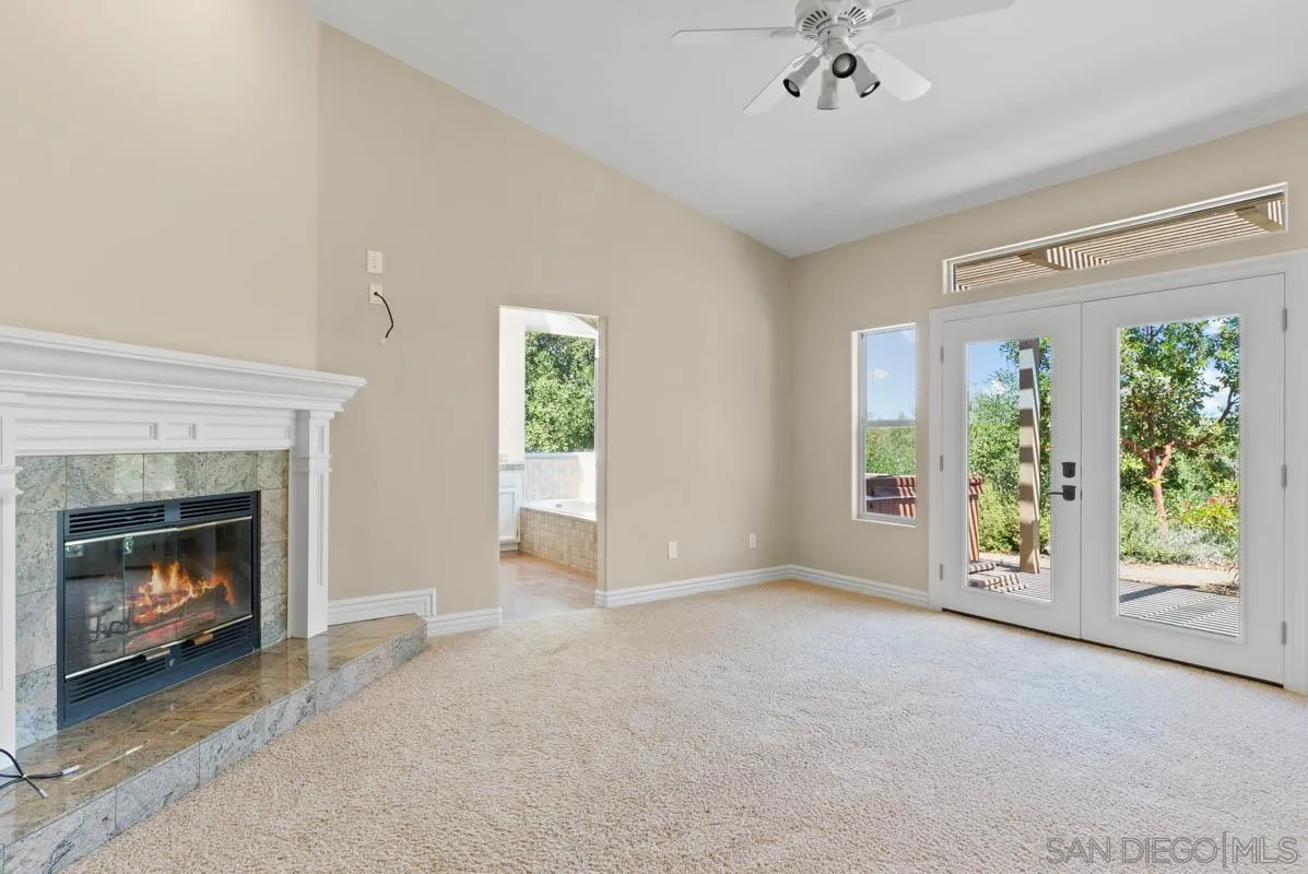 544 Alpine Trail Road Alpine, CA 91901 - Photo 26 of 52 a view of an empty room with a fireplace and a window