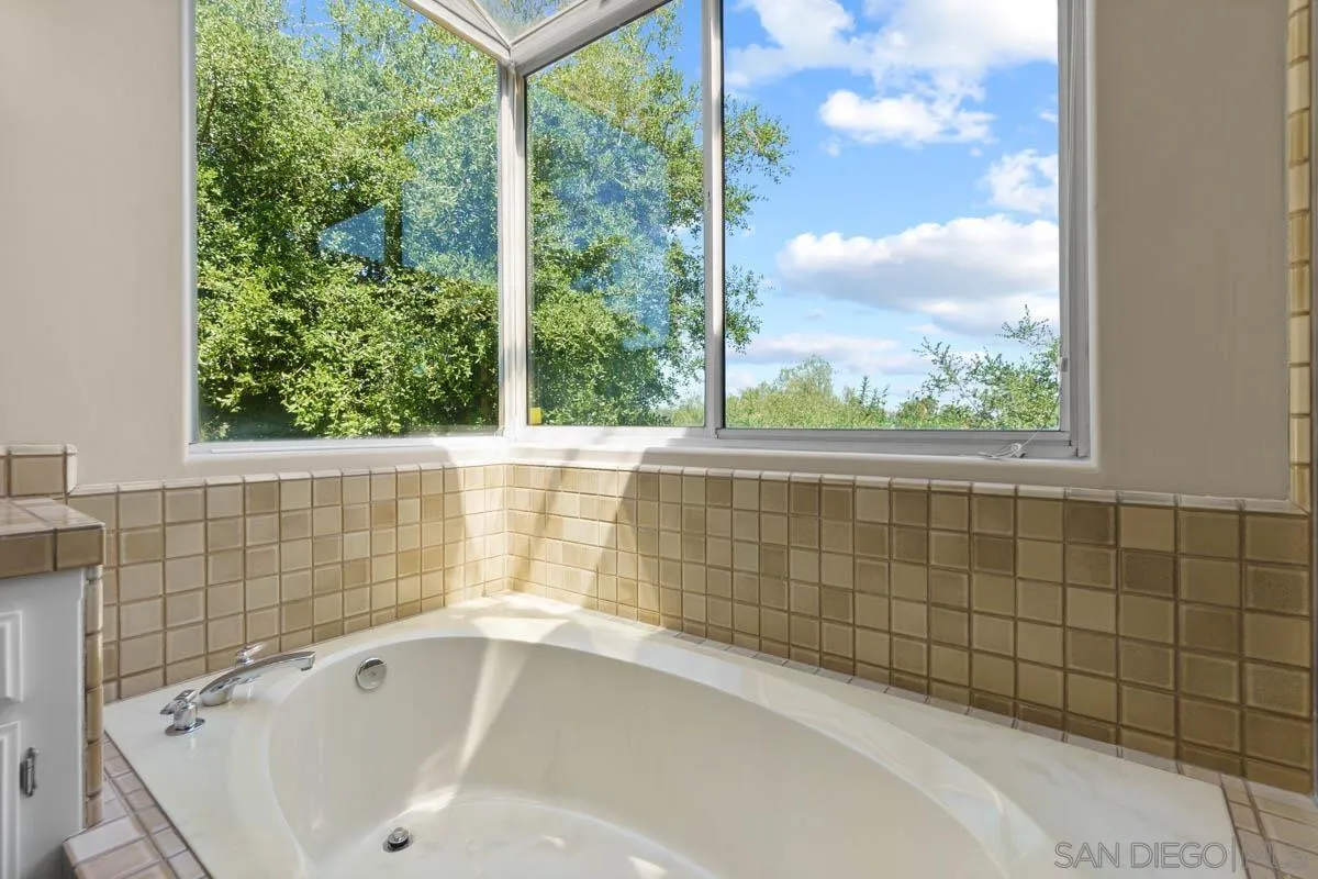 544 Alpine Trail Road Alpine, CA 91901 - Photo 28 of 52 a bathroom with a bathtub and window