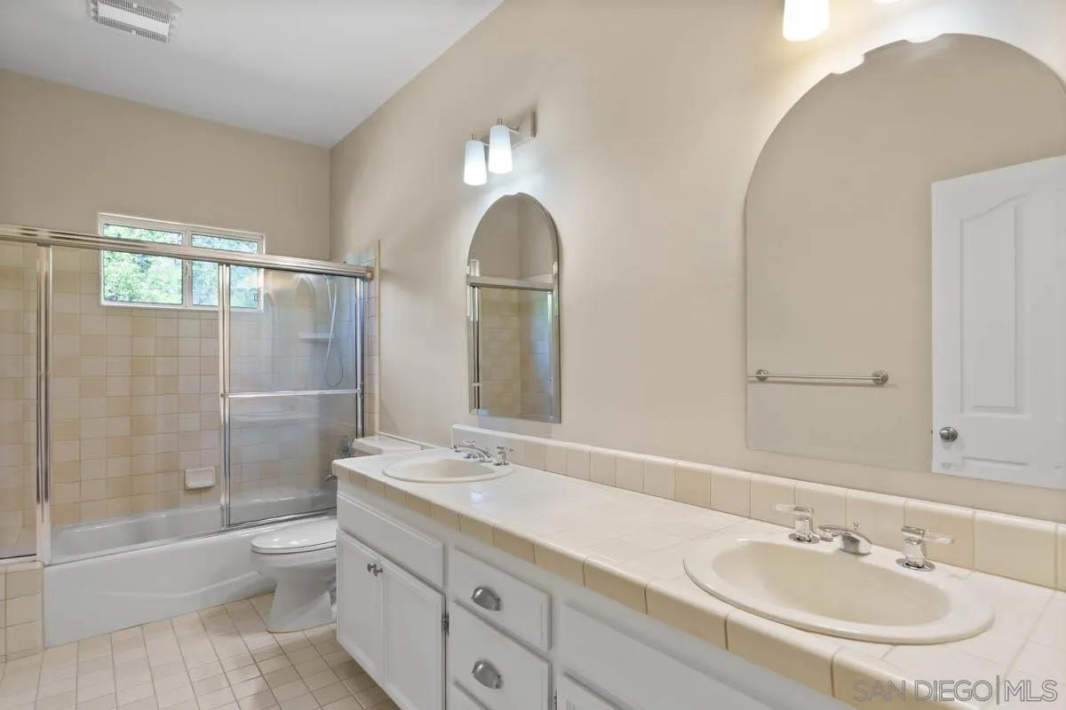544 Alpine Trail Road Alpine, CA 91901 - Photo 35 of 52 a bathroom with a sink double vanity and a mirror