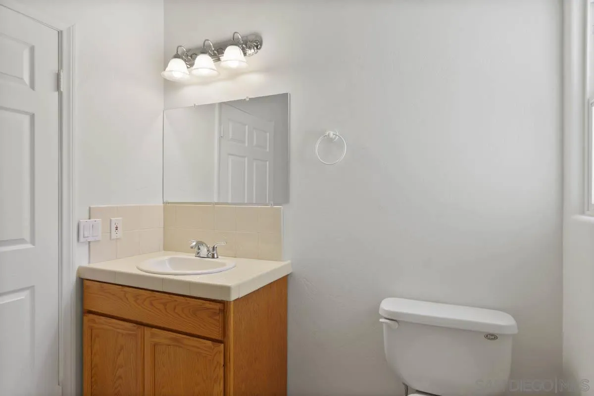 544 Alpine Trail Road Alpine, CA 91901 - Photo 40 of 52 a bathroom with a sink mirror and toilet