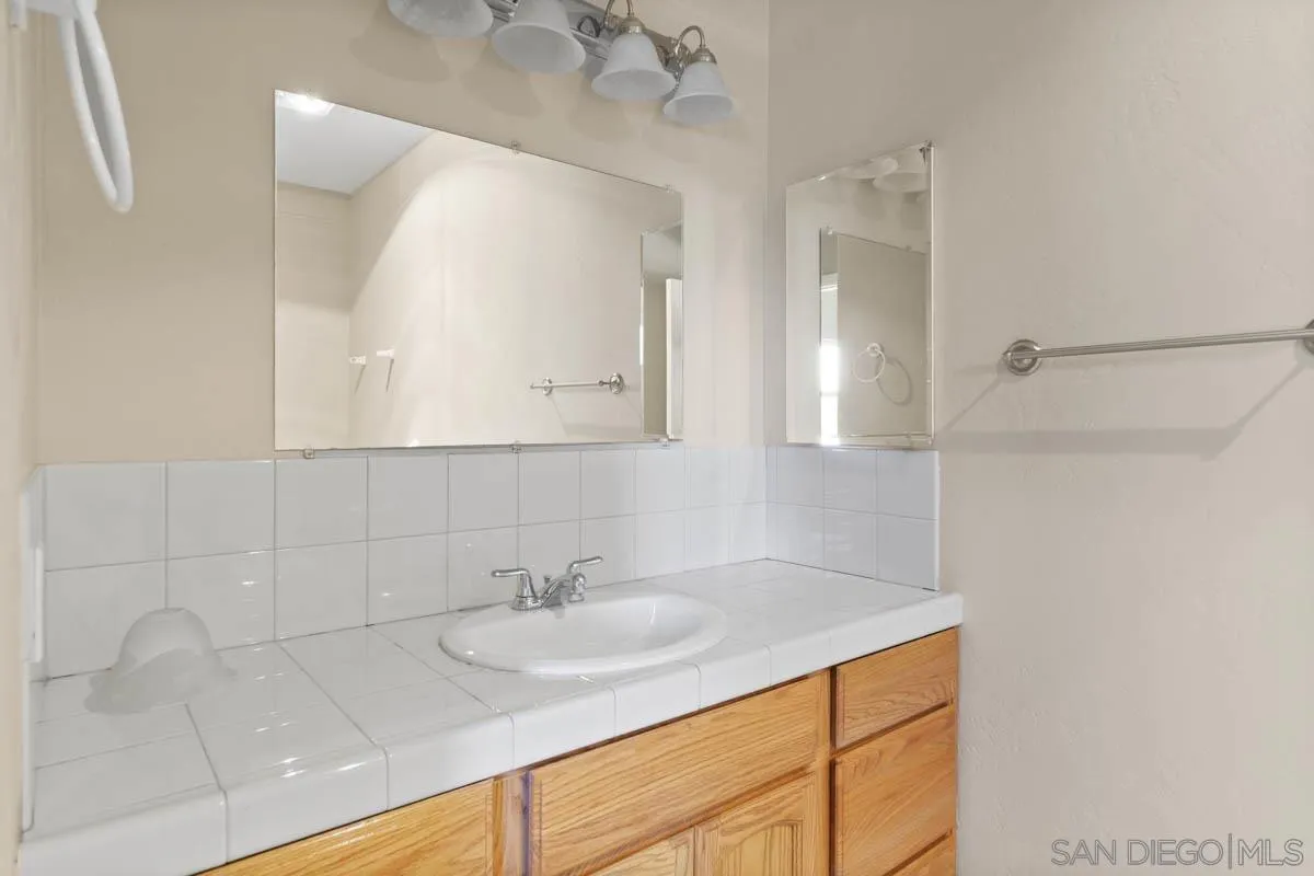 544 Alpine Trail Road Alpine, CA 91901 - Photo 47 of 52 a bathroom with a sink and a mirror