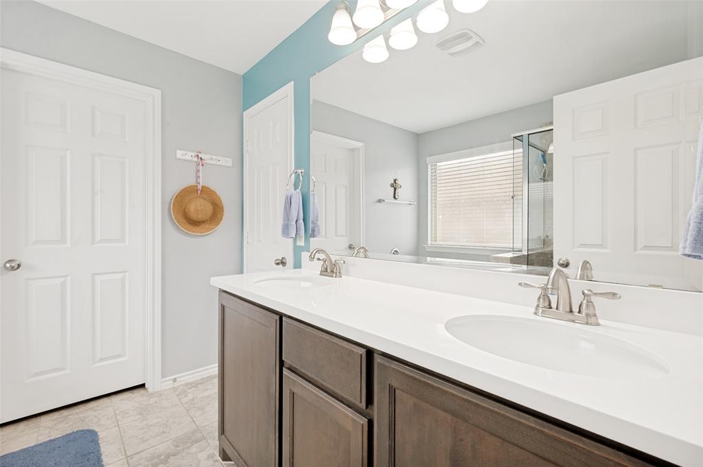 3905 Bridle Path Lane Sanger, TX 76266 - Photo 16 of 26 a bathroom with a sink double vanity and a mirror