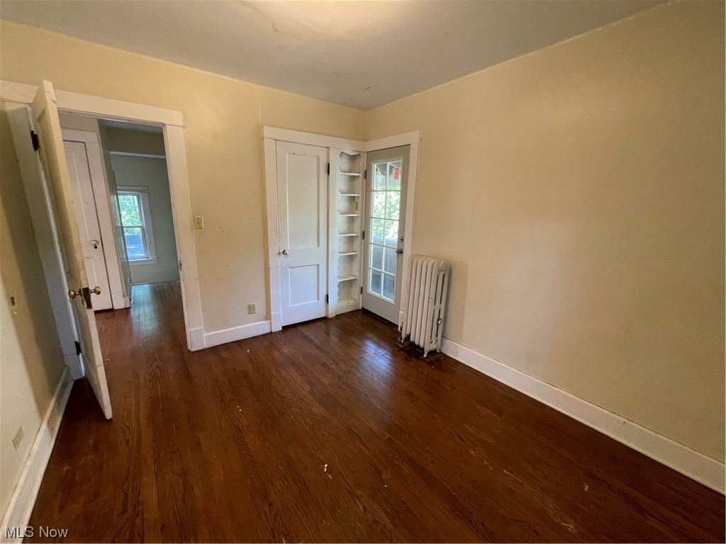 1730 Wood Road Cleveland Heights, OH 44121 - Photo 27 of 34 Hardwood floored bedroom featuring multiple windows and radiator