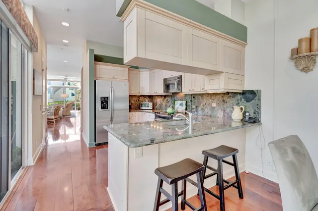 a view of a dining room with furniture wooden floor and a chandelier