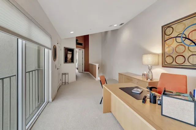 a view of a room with a large window and front door