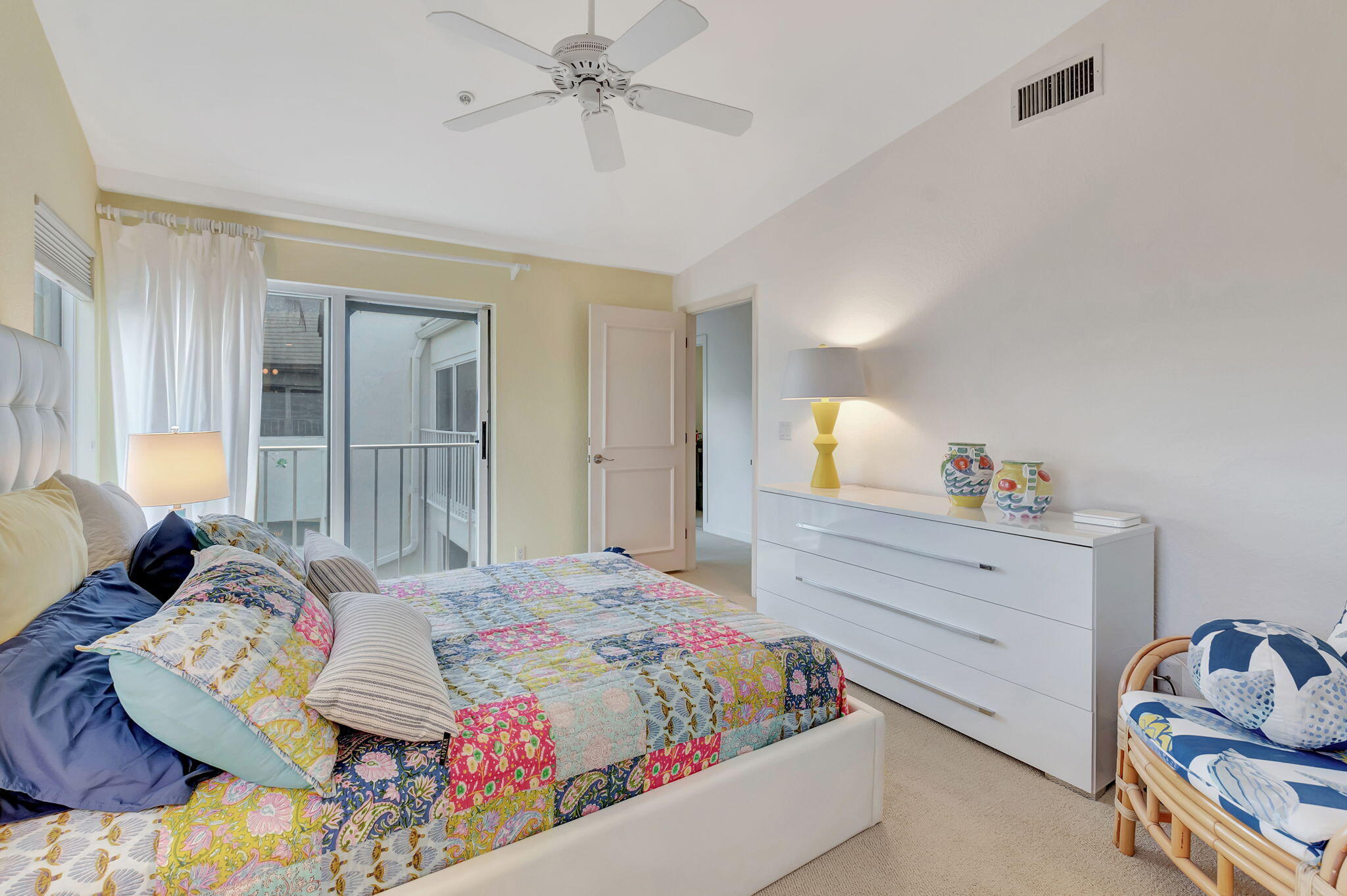 2115 South Ocean Boulevard, Unit 14 Delray Beach, FL 33483 - Photo 35 of 56 a bedroom with a bed and a chandelier