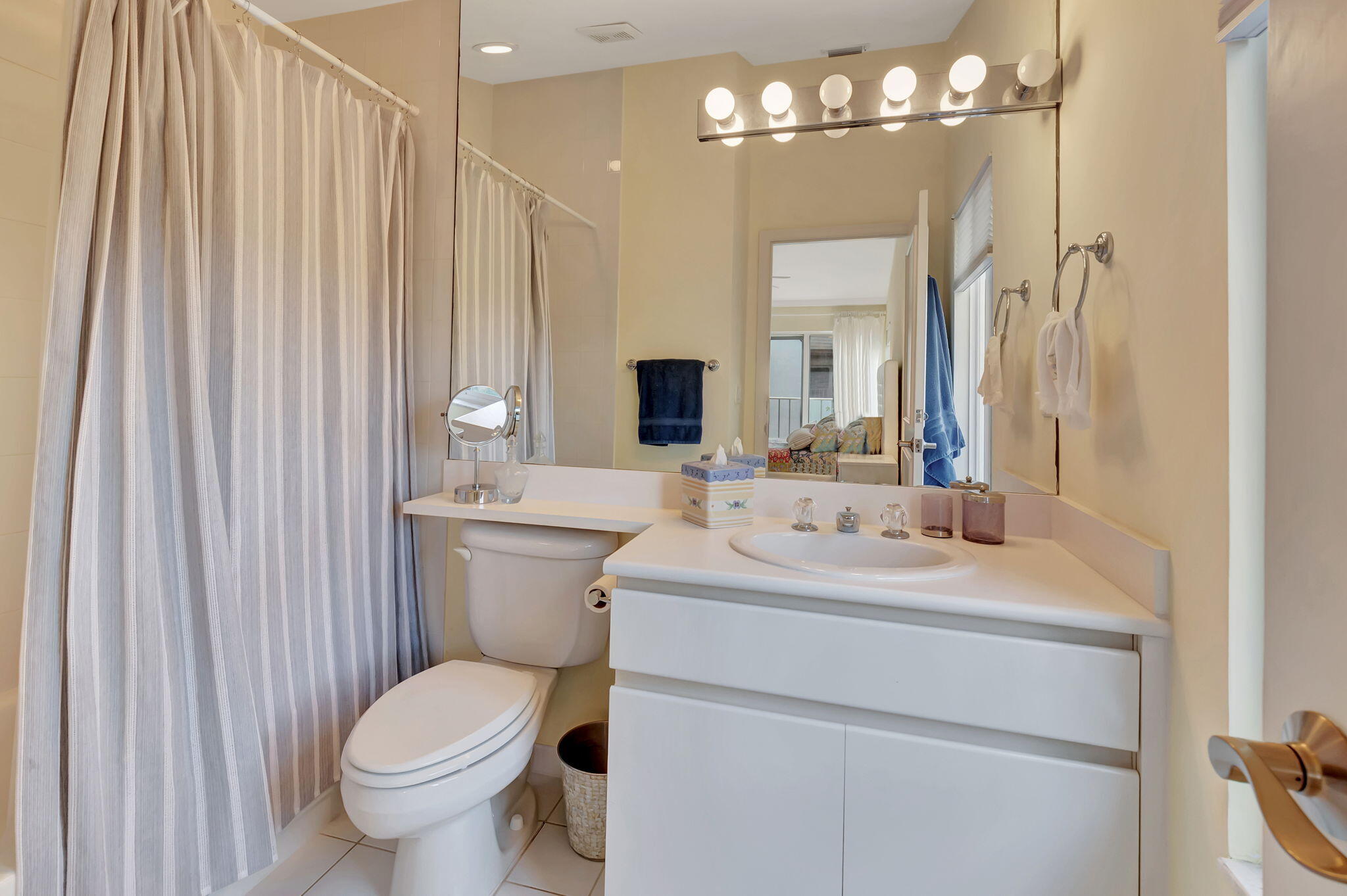 2115 South Ocean Boulevard, Unit 14 Delray Beach, FL 33483 - Photo 36 of 56 a bathroom with a toilet sink and mirror