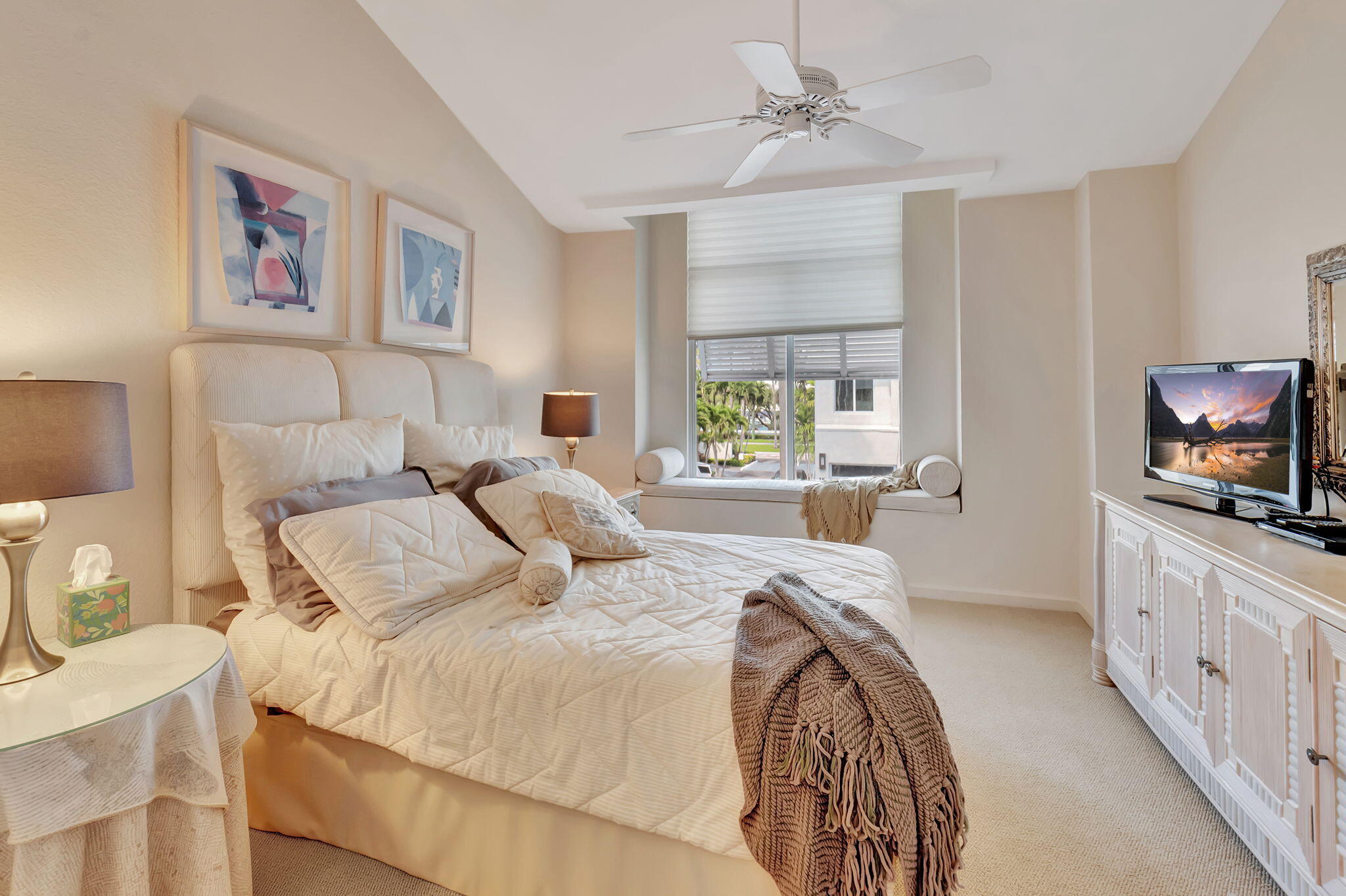 2115 South Ocean Boulevard, Unit 14 Delray Beach, FL 33483 - Photo 37 of 56 a bedroom with a large bed and a chandelier