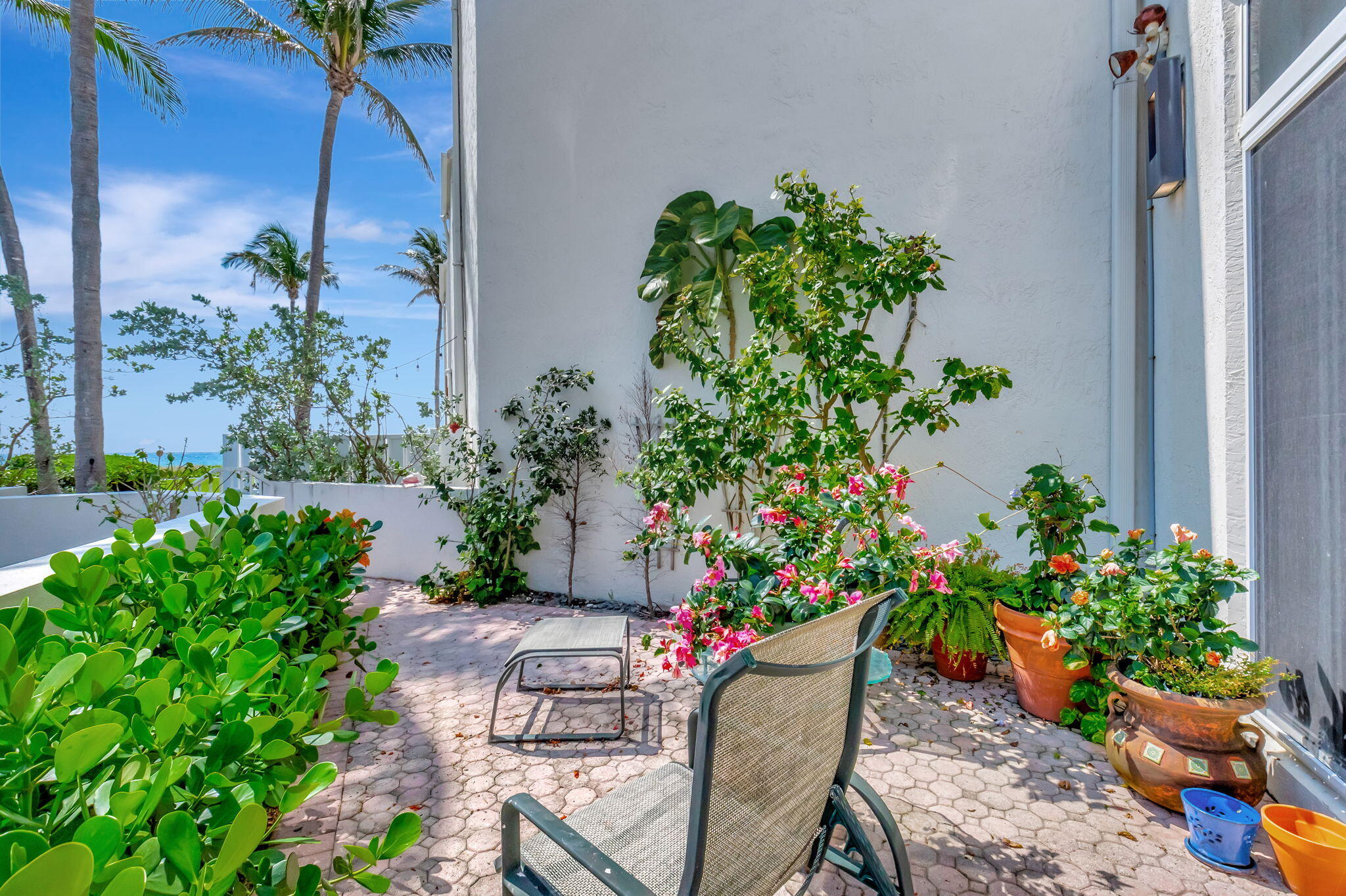 2115 South Ocean Boulevard, Unit 14 Delray Beach, FL 33483 - Photo 10 of 56 a view of a backyard with chair and flower plants