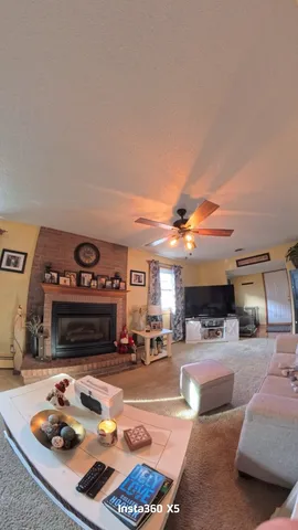 a room with furniture a flat screen tv and a couch