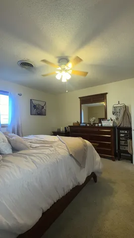 a bedroom with a bed and a night stand