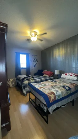a bedroom with a bed and a lamp