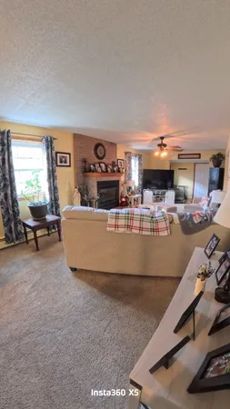 a living room with furniture and a pool table