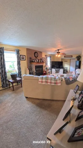 a living room with furniture and a pool table