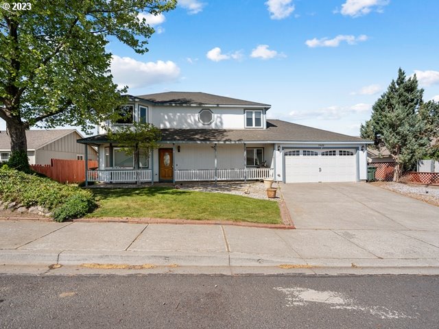 2488 Pheasant Ridge Street Umatilla, OR 97882 - Photo 2 of 40 a view of a white house with a yard and plants