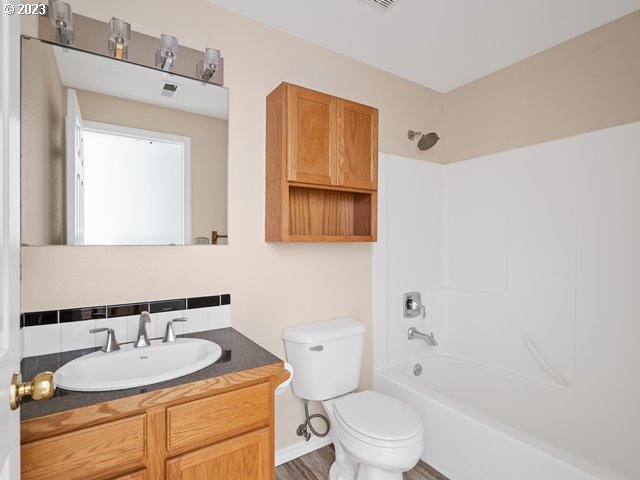 2488 Pheasant Ridge Street Umatilla, OR 97882 - Photo 22 of 40 a bathroom with a granite countertop toilet a sink and a mirror