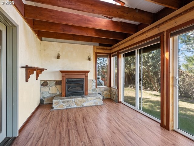 2488 Pheasant Ridge Street Umatilla, OR 97882 - Photo 27 of 40 a view of an empty room with wooden floor fireplace and a window