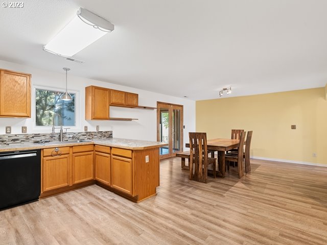 2488 Pheasant Ridge Street Umatilla, OR 97882 - Photo 10 of 40 a kitchen with stainless steel appliances granite countertop dining table chairs and granite counter tops