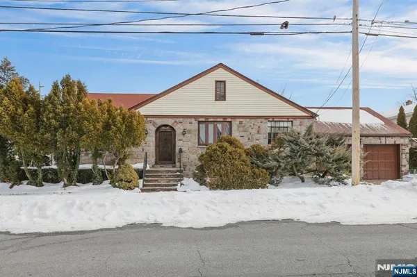 a view of a house with a snow in the background