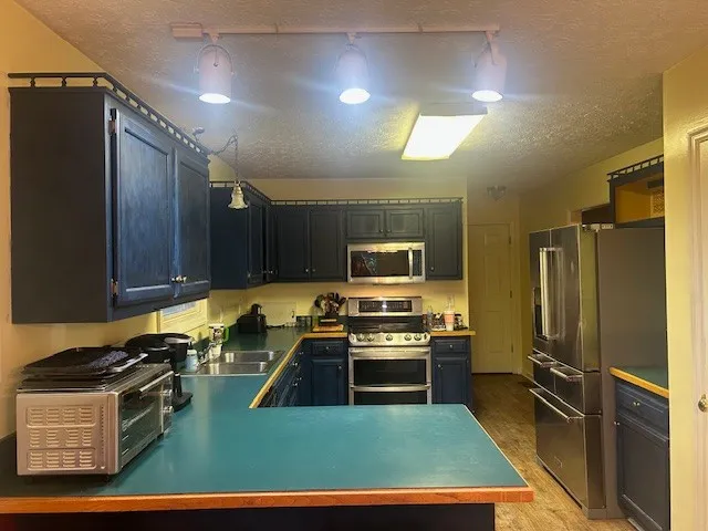 a kitchen with wooden cabinets and stainless steel appliances