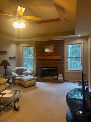 a living room with furniture a fireplace and a chandelier