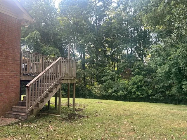 a view of an ocean with a small yard and wooden fence
