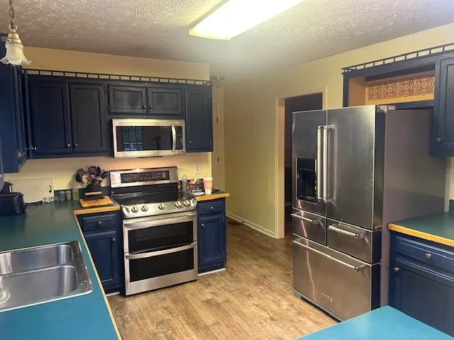 a kitchen with a refrigerator stove and microwave