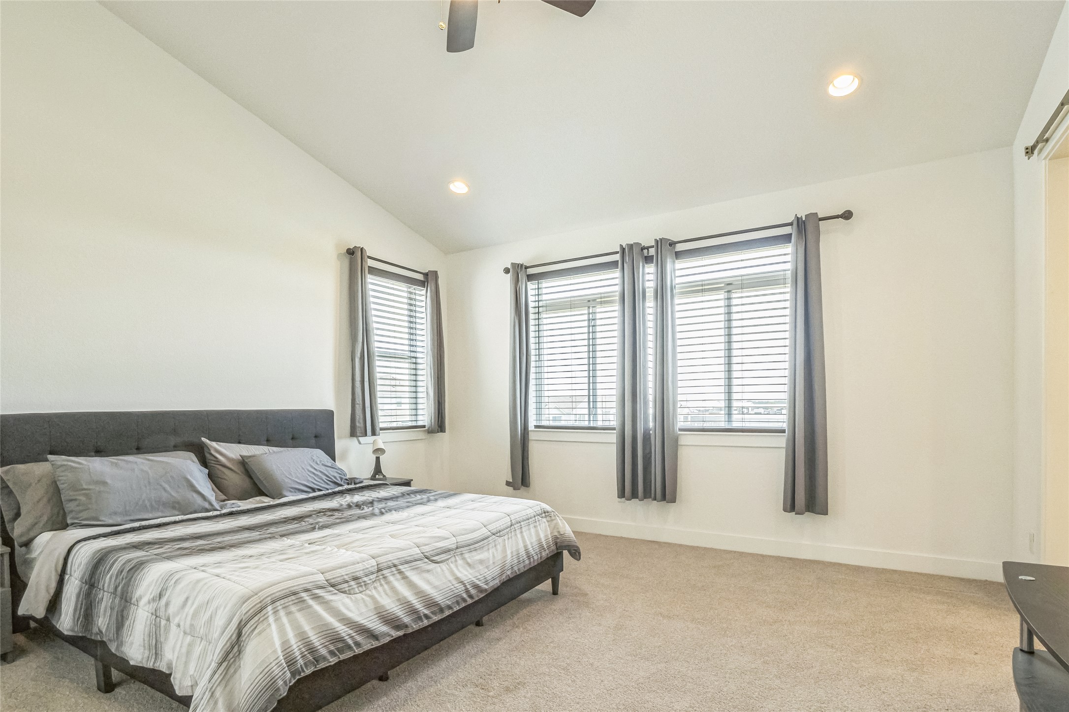 3706 Mesquite Vly Road Georgetown, TX 78628 - Photo 10 of 30 Bedroom with light colored carpet, recessed lighting, vaulted ceiling, baseboards, and ceiling fan