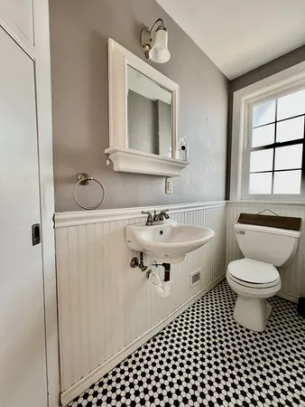 a bathroom with a sink toilet a mirror and shower