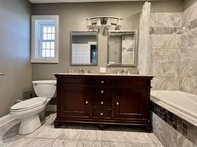 a bathroom with a sink a toilet and bathtub