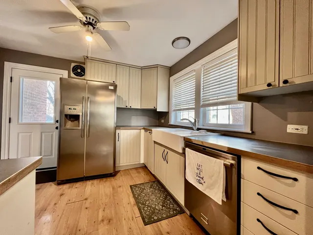 a kitchen with stainless steel appliances a refrigerator sink and cabinets