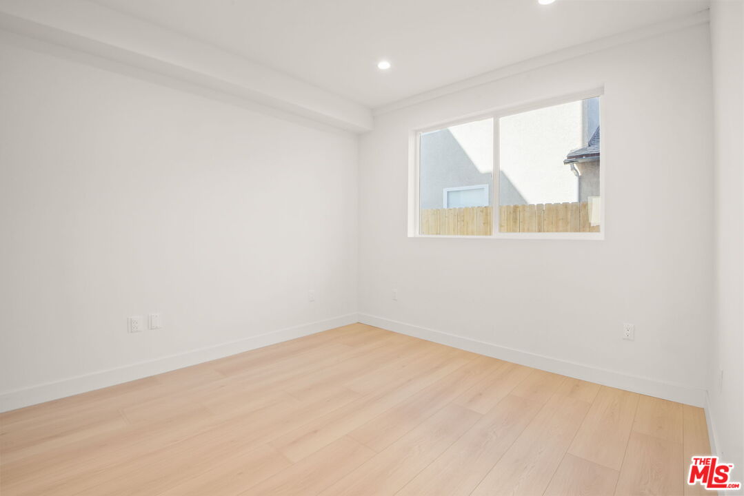1707 South Burnside Avenue, Unit 1/2 Los Angeles, CA 90019 - Photo 12 of 30 an empty room with a window