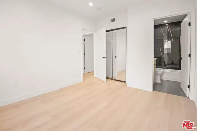 a view of a room with a bed and cabinet