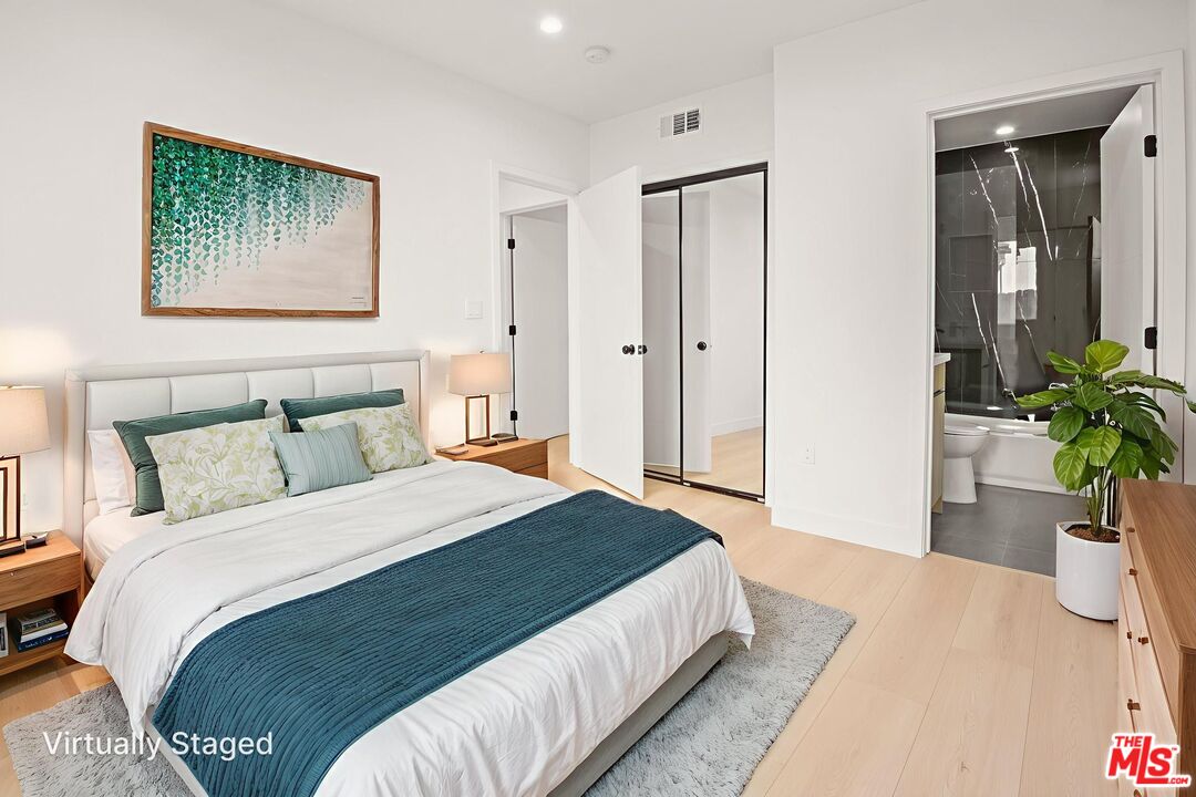 1707 South Burnside Avenue, Unit 1/2 Los Angeles, CA 90019 - Photo 14 of 30 a bedroom with a bed and a potted plant