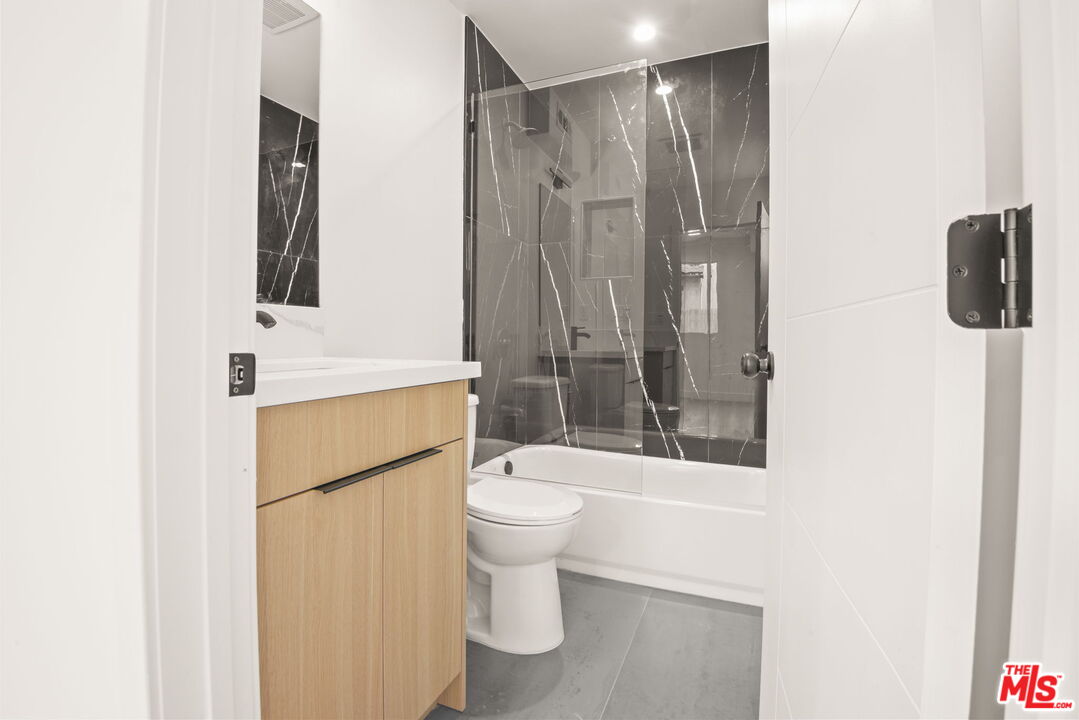 1707 South Burnside Avenue, Unit 1/2 Los Angeles, CA 90019 - Photo 16 of 30 a bathroom with a toilet sink and shower