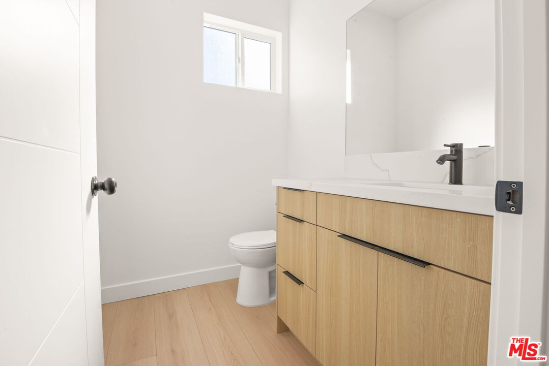 1707 South Burnside Avenue, Unit 1/2 Los Angeles, CA 90019 - Photo 18 of 30 a bathroom with a sink a toilet and vanity