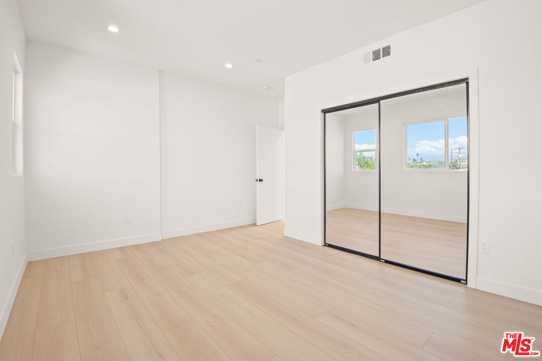 1707 South Burnside Avenue, Unit 1/2 Los Angeles, CA 90019 - Photo 26 of 30 an empty room with closet and a glass door shower