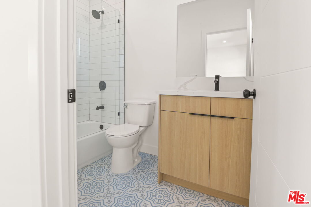 1707 South Burnside Avenue, Unit 1/2 Los Angeles, CA 90019 - Photo 27 of 30 a bathroom with a toilet sink and a mirror
