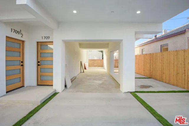 a view of a hallway with closet and bathroom