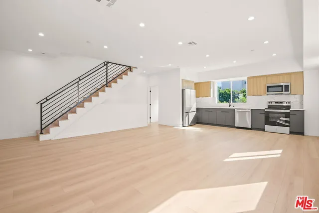 a view of a kitchen with a sink and a refrigerator