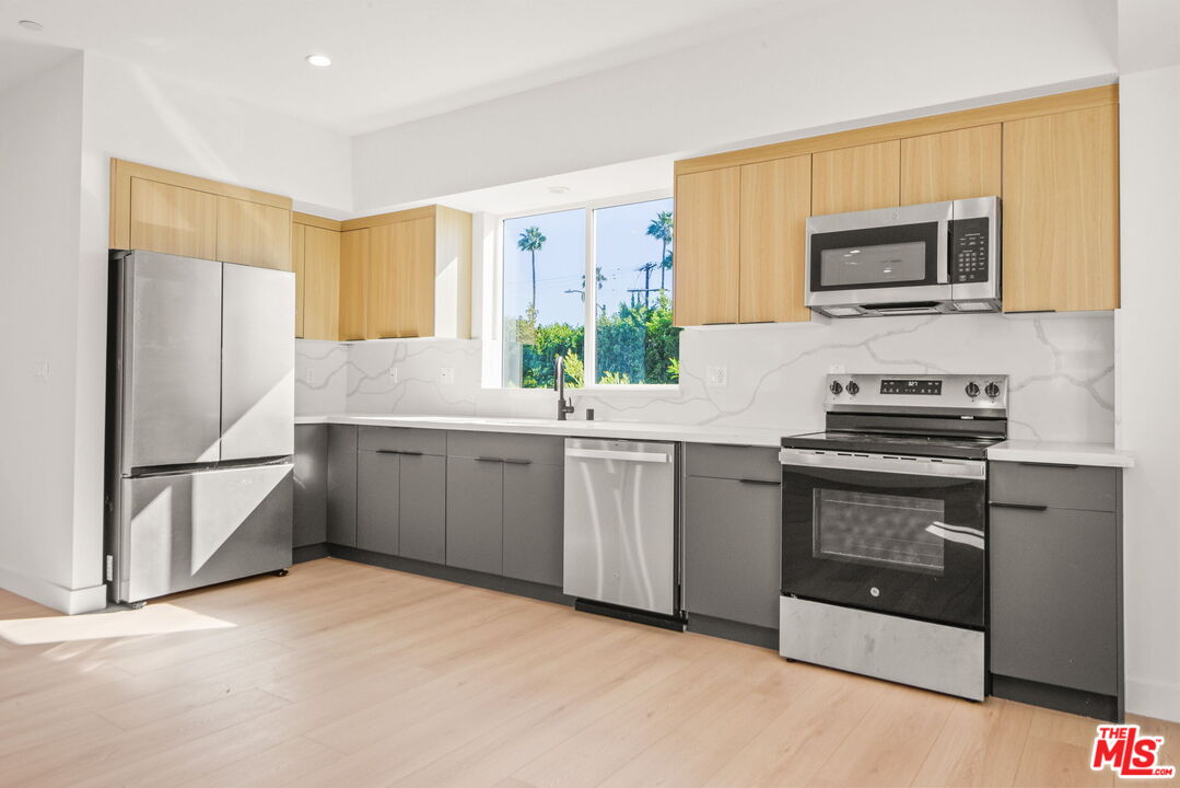 1707 South Burnside Avenue, Unit 1/2 Los Angeles, CA 90019 - Photo 4 of 30 a kitchen with a refrigerator sink and microwave