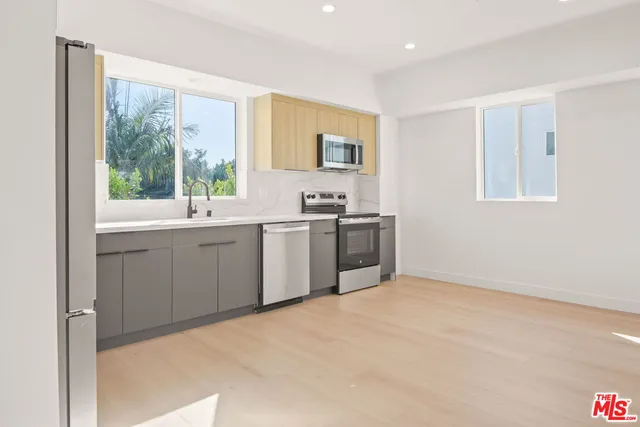 a kitchen with a sink stove and cabinets